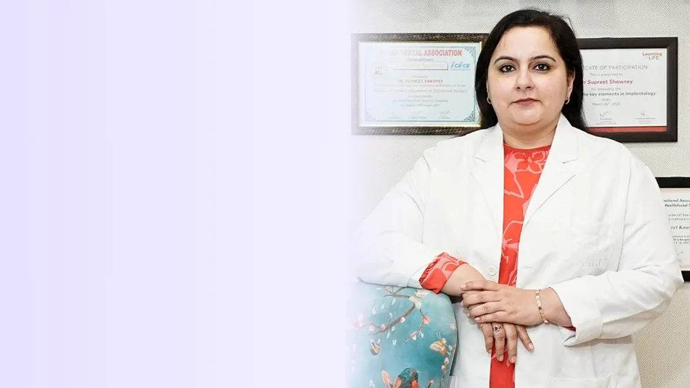Dr. Supreet Kaur Sawhney in a white coat with professional certificates in the background